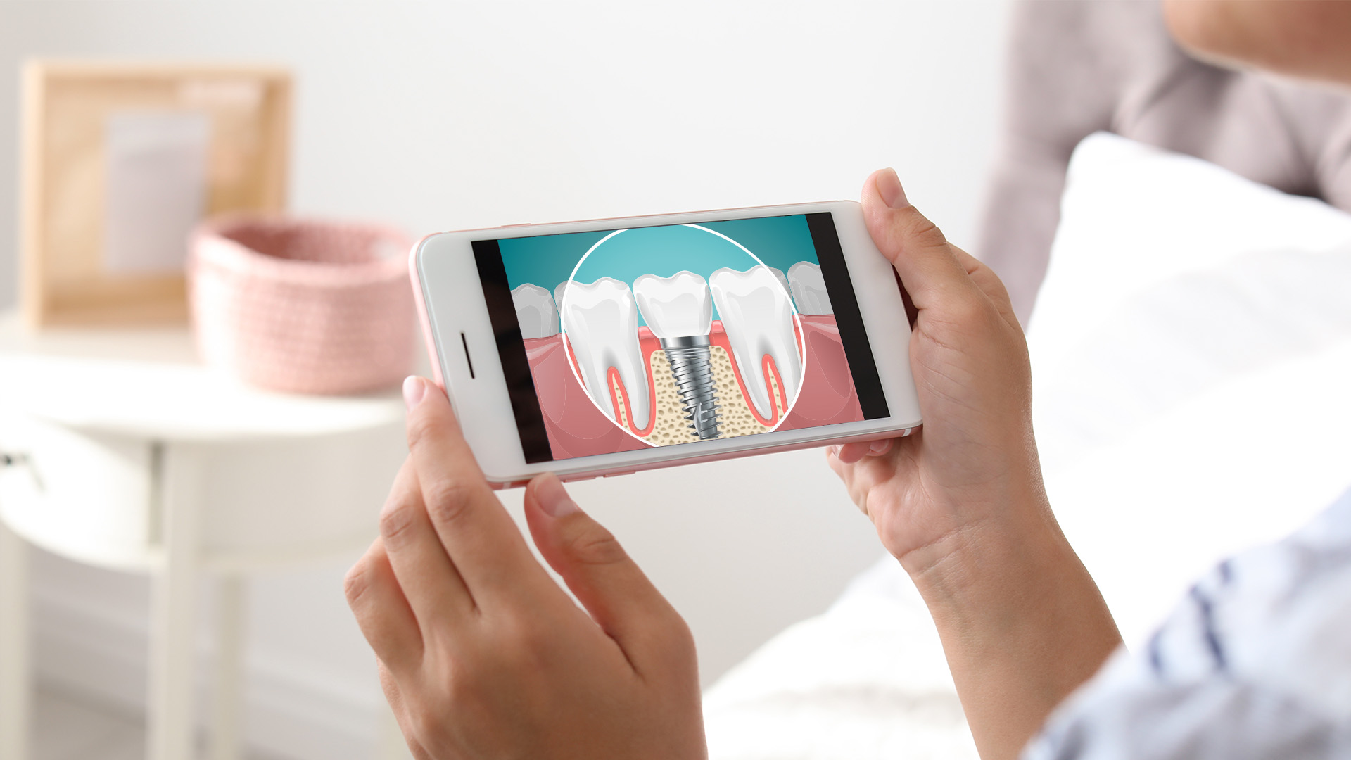 A person is holding a smartphone displaying an image of a tooth with a cavity, likely for dental education or awareness.